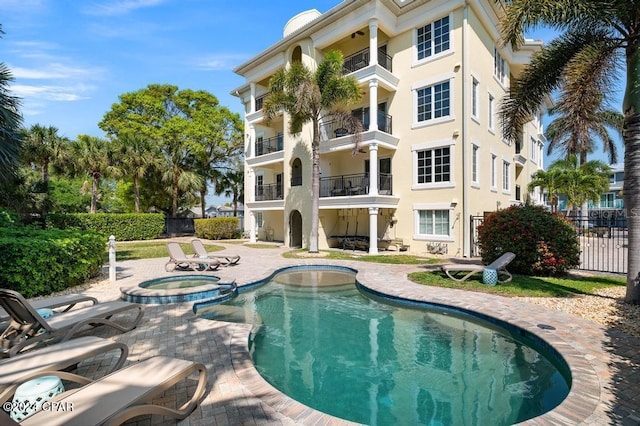 view of swimming pool with an in ground hot tub and a patio area