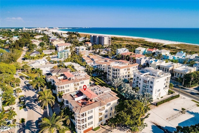 drone / aerial view featuring a water view and a beach view