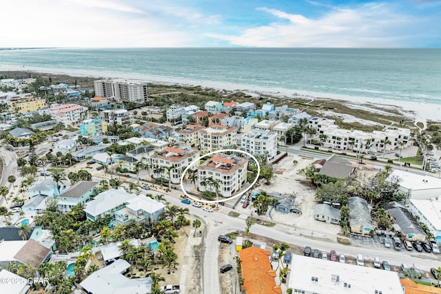 aerial view with a water view and a beach view