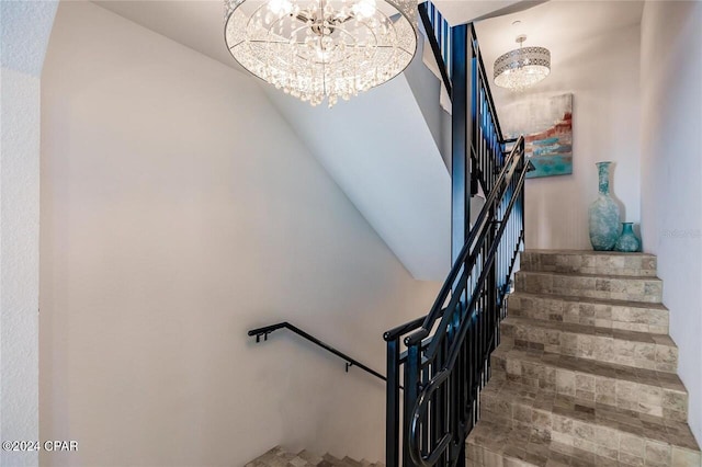 stairs with an inviting chandelier