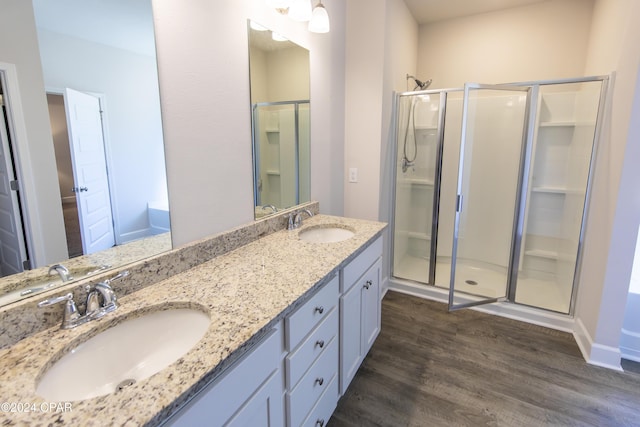 bathroom featuring hardwood / wood-style floors, vanity, and an enclosed shower