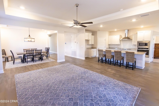 living room with dark wood-type flooring and ceiling fan with notable chandelier