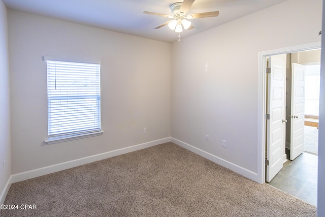 carpeted empty room with ceiling fan