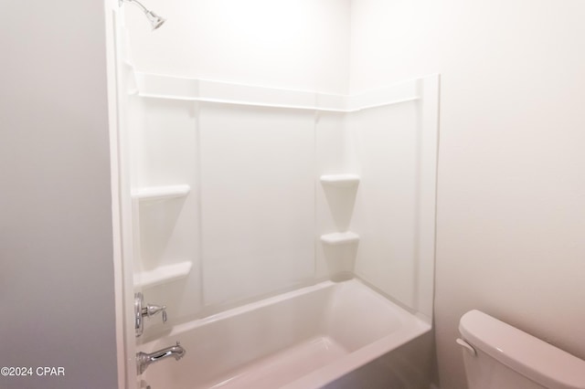 bathroom with toilet and bathing tub / shower combination