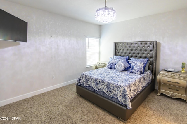 bedroom featuring carpet and a chandelier