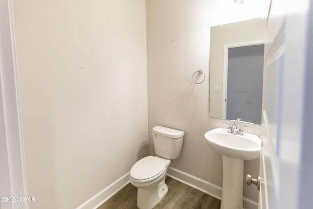 bathroom featuring sink, hardwood / wood-style floors, and toilet