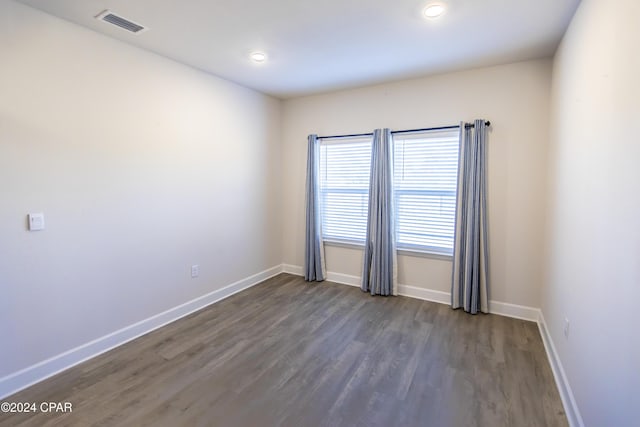 empty room with dark hardwood / wood-style flooring