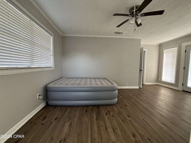 unfurnished room featuring ceiling fan, dark hardwood / wood-style floors, and ornamental molding