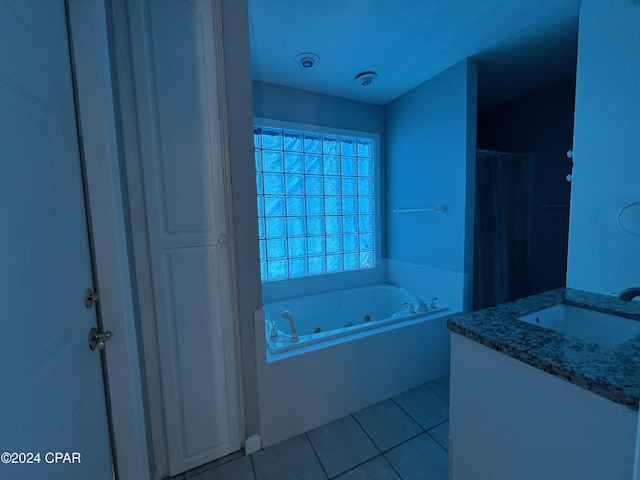 bathroom featuring tile patterned floors, a bathtub, and vanity