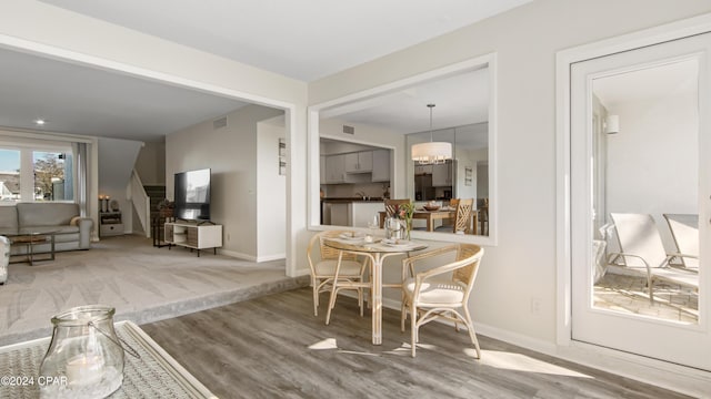 dining room with hardwood / wood-style floors and sink