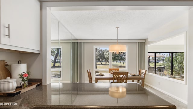 dining area featuring a textured ceiling