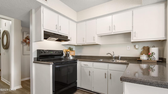 kitchen with a textured ceiling, dark wood-type flooring, sink, electric range, and white cabinets