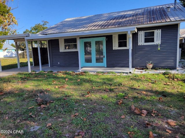 rear view of property with a yard