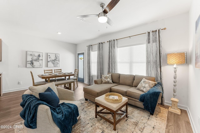 living room with light hardwood / wood-style floors and ceiling fan