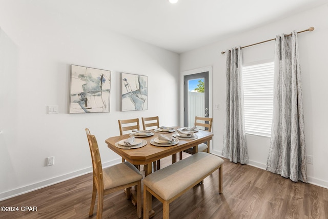 dining space with dark hardwood / wood-style floors