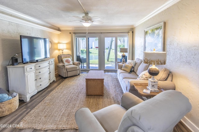 living room featuring a textured ceiling, crown molding, ceiling fan, and dark wood-type flooring