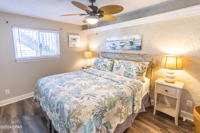 bedroom with ceiling fan, dark hardwood / wood-style flooring, ornamental molding, and a textured ceiling