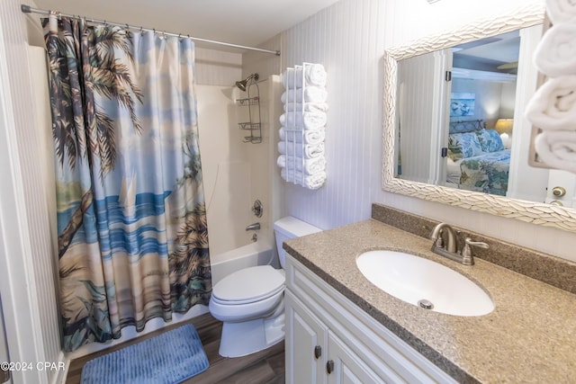 full bathroom with vanity, shower / bathtub combination with curtain, wood-type flooring, and toilet