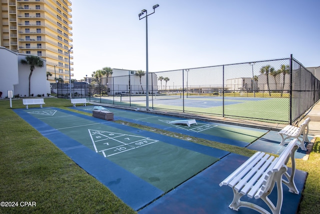 view of community featuring tennis court