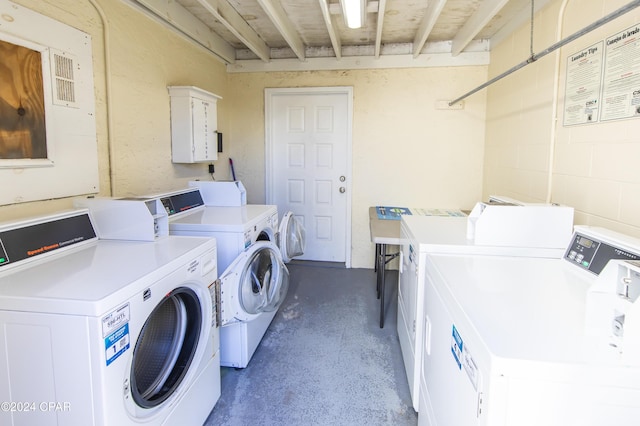 clothes washing area featuring washer and clothes dryer