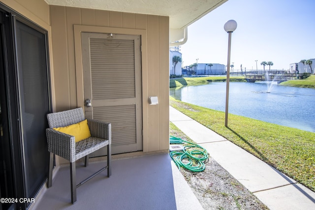 view of patio with a water view