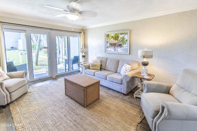 living room with a textured ceiling, light hardwood / wood-style floors, ceiling fan, and crown molding