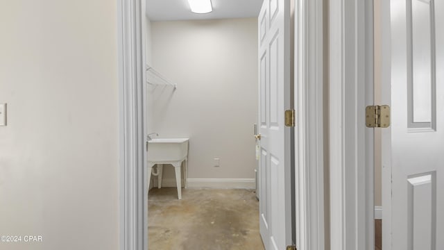 interior space with baseboards and a sink