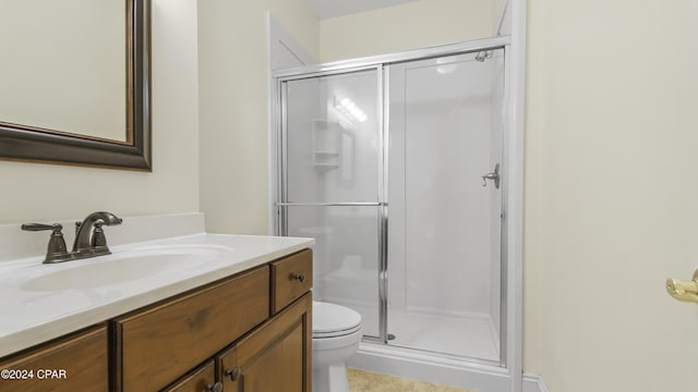 full bathroom featuring vanity, a shower stall, and toilet
