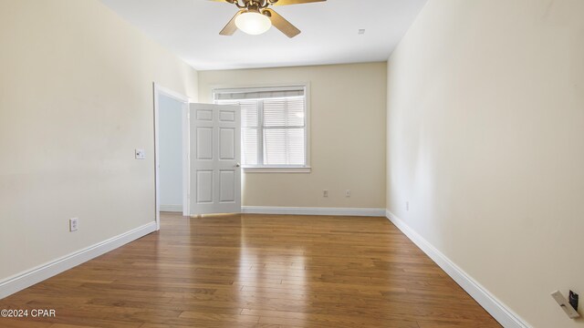 unfurnished bedroom with ensuite bath, a spacious closet, ceiling fan, light hardwood / wood-style flooring, and a closet