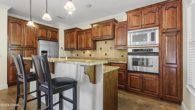 kitchen with a breakfast bar area, visible vents, appliances with stainless steel finishes, crown molding, and tasteful backsplash