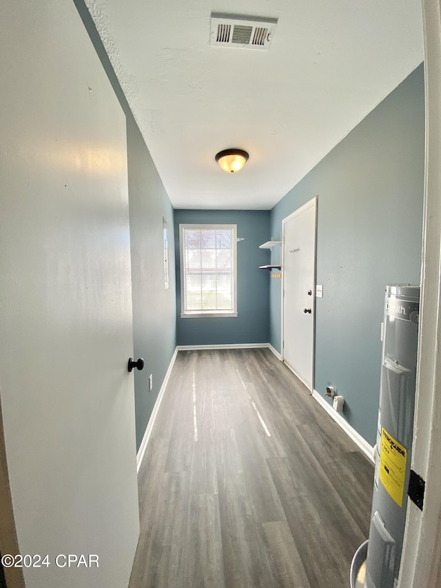 interior space with hardwood / wood-style flooring and water heater