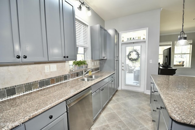 kitchen featuring dishwasher, gray cabinets, sink, and tasteful backsplash