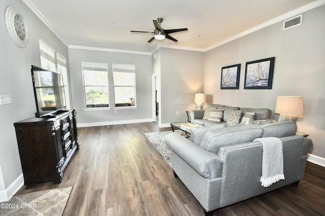 living room with dark hardwood / wood-style flooring, ceiling fan, and crown molding