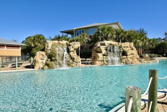 view of pool with pool water feature