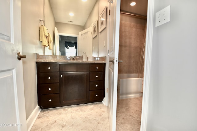 bathroom featuring vanity, tile patterned floors, and tub / shower combination