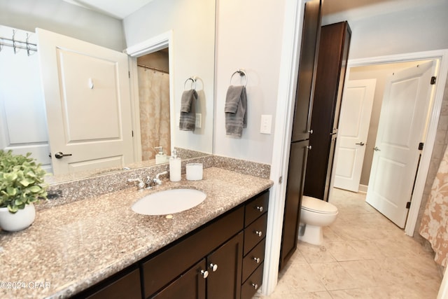 bathroom featuring tile patterned flooring, vanity, and toilet