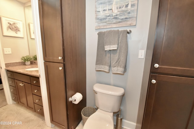 bathroom featuring tile patterned flooring, vanity, and toilet