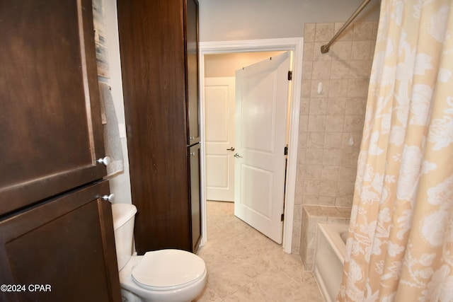 bathroom with tile patterned floors, toilet, and shower / tub combo