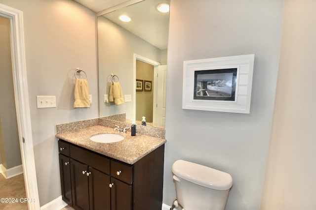 bathroom featuring tile patterned flooring, vanity, and toilet