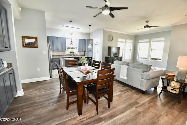 dining area with dark hardwood / wood-style flooring, ceiling fan, and ornamental molding