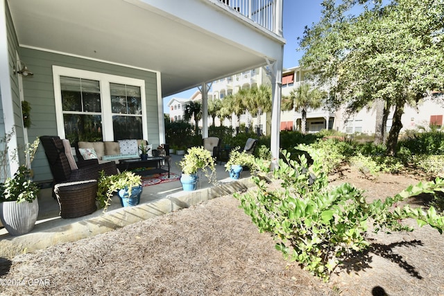 view of patio with outdoor lounge area and a balcony