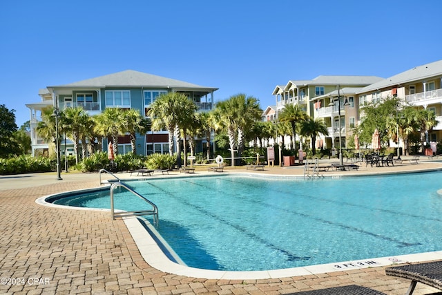 view of swimming pool featuring a patio area