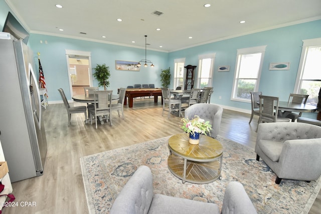 living room featuring light hardwood / wood-style floors and crown molding