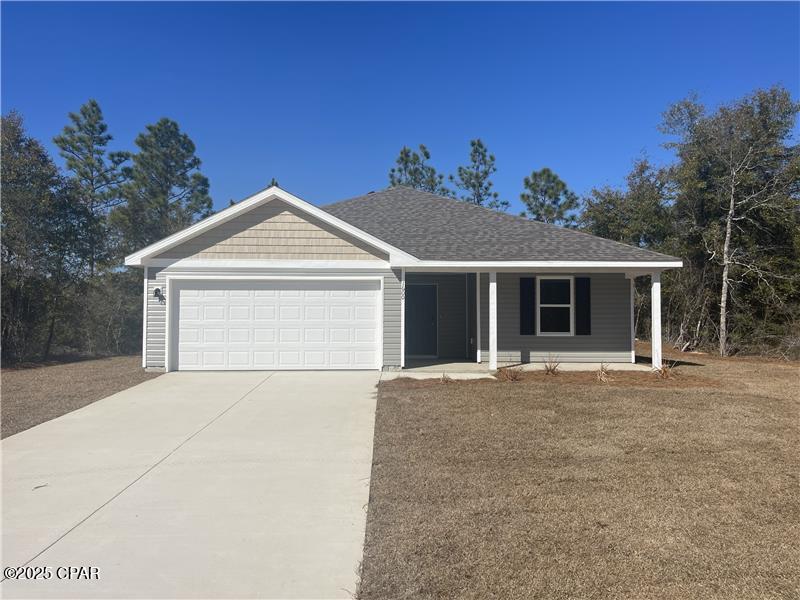 ranch-style home with a garage and covered porch