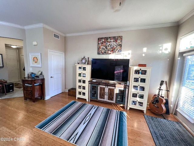 living room with crown molding and hardwood / wood-style floors