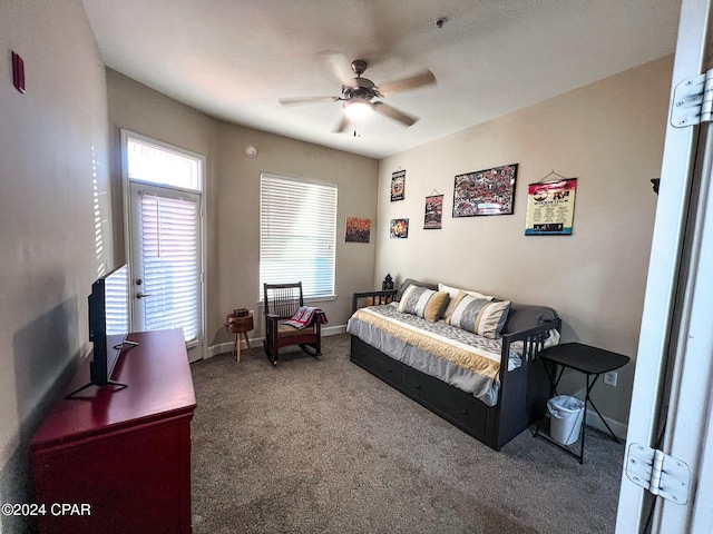 bedroom featuring ceiling fan and carpet