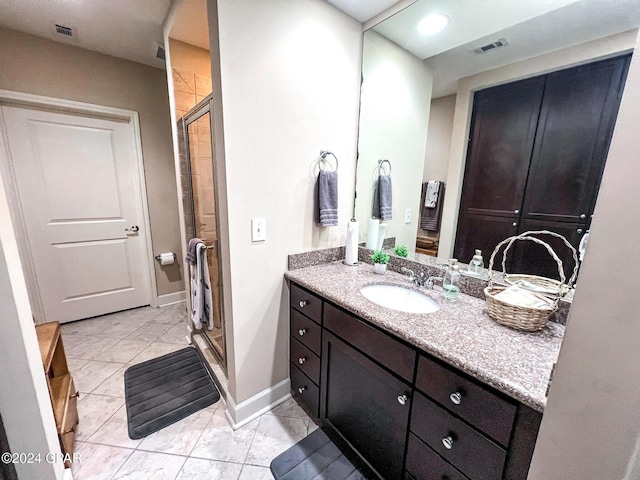 bathroom with vanity and a shower with shower door