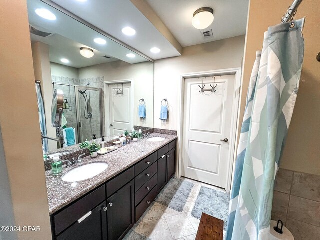 bathroom with tile patterned floors, vanity, and an enclosed shower