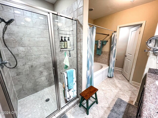 bathroom with vanity, shower with separate bathtub, and tile patterned flooring