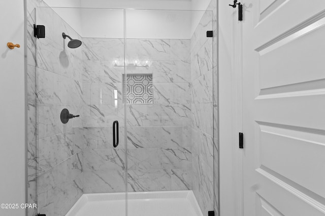 bathroom with a shower with door